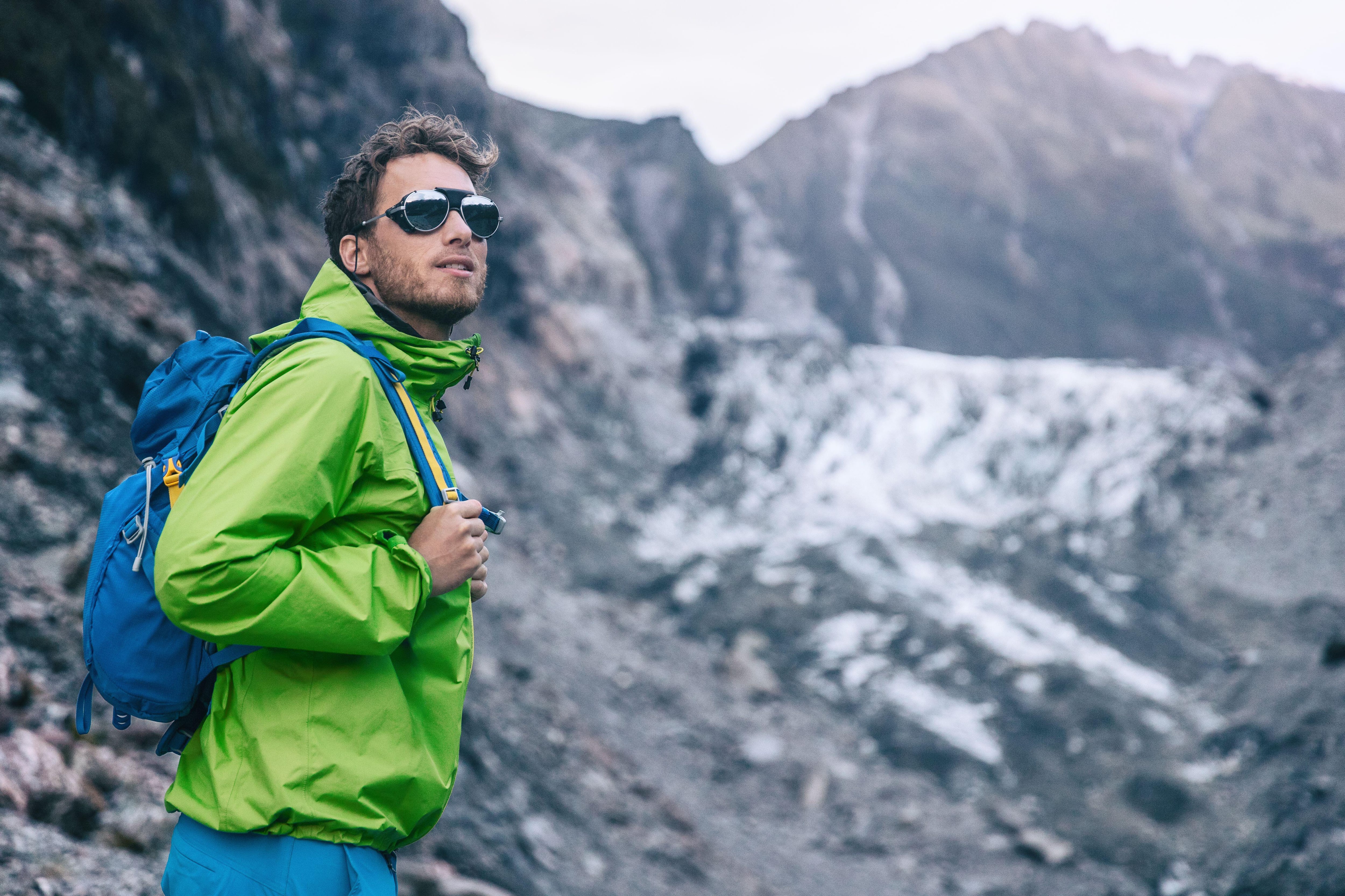 Tourist explorer backpacking in nature landscape by Franz Josef Glacier, Westland Tai Poutini National Park, New Zealand
