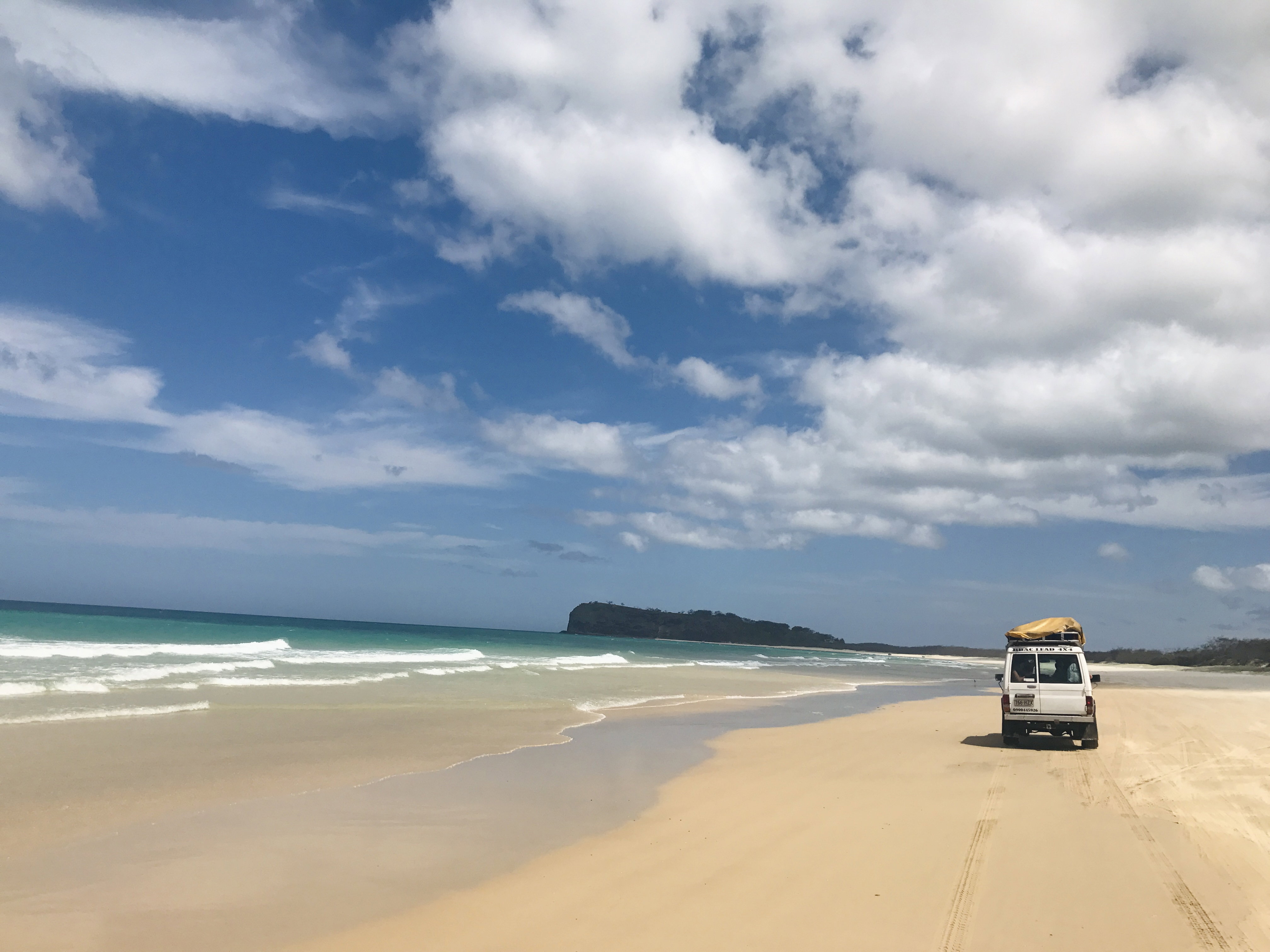 A car on the beach on Fraser Island in Australia