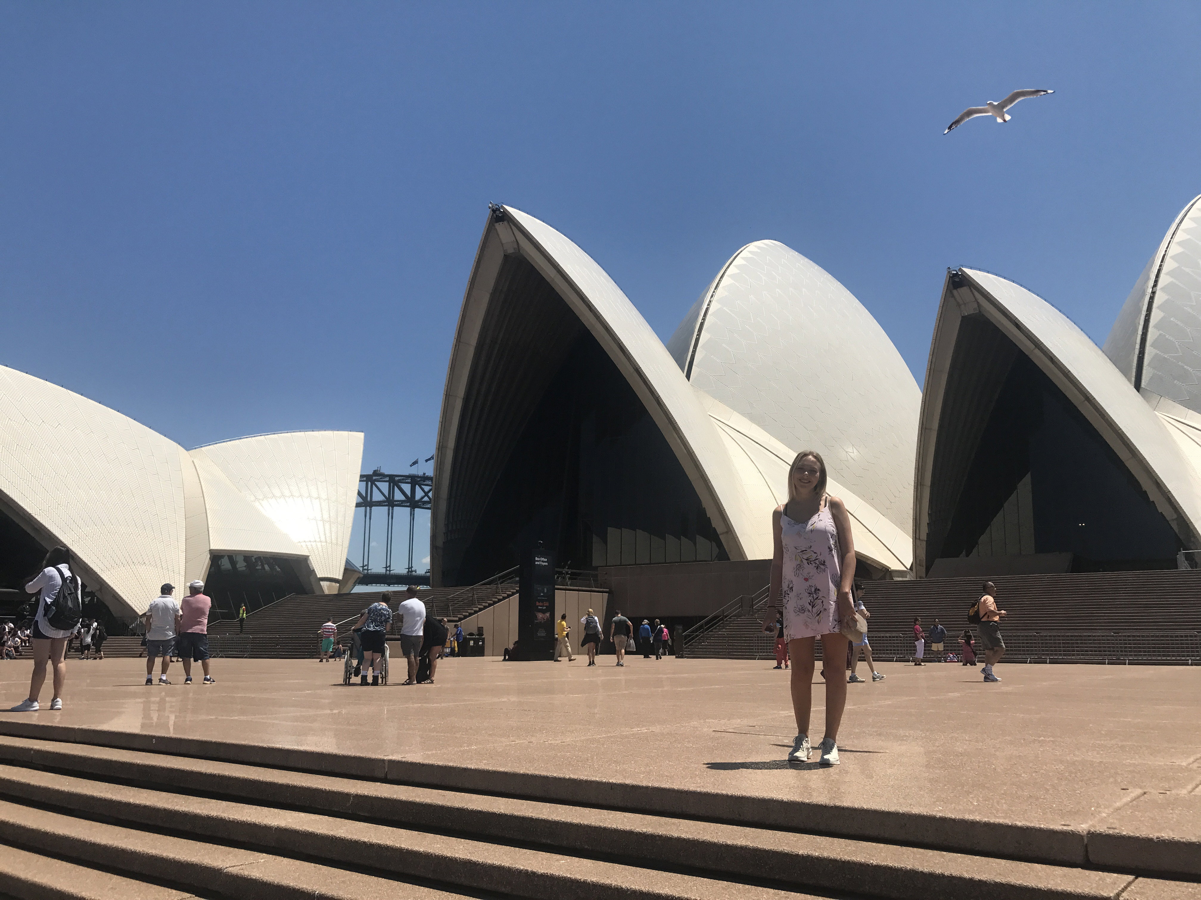 Emily stood outside the Sydney Opera House in Australia
