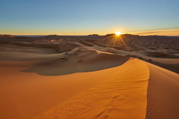 Sun is rising in the desert . Sunrise desert landscape photo was taken in Erg Chebbi near Merzouga