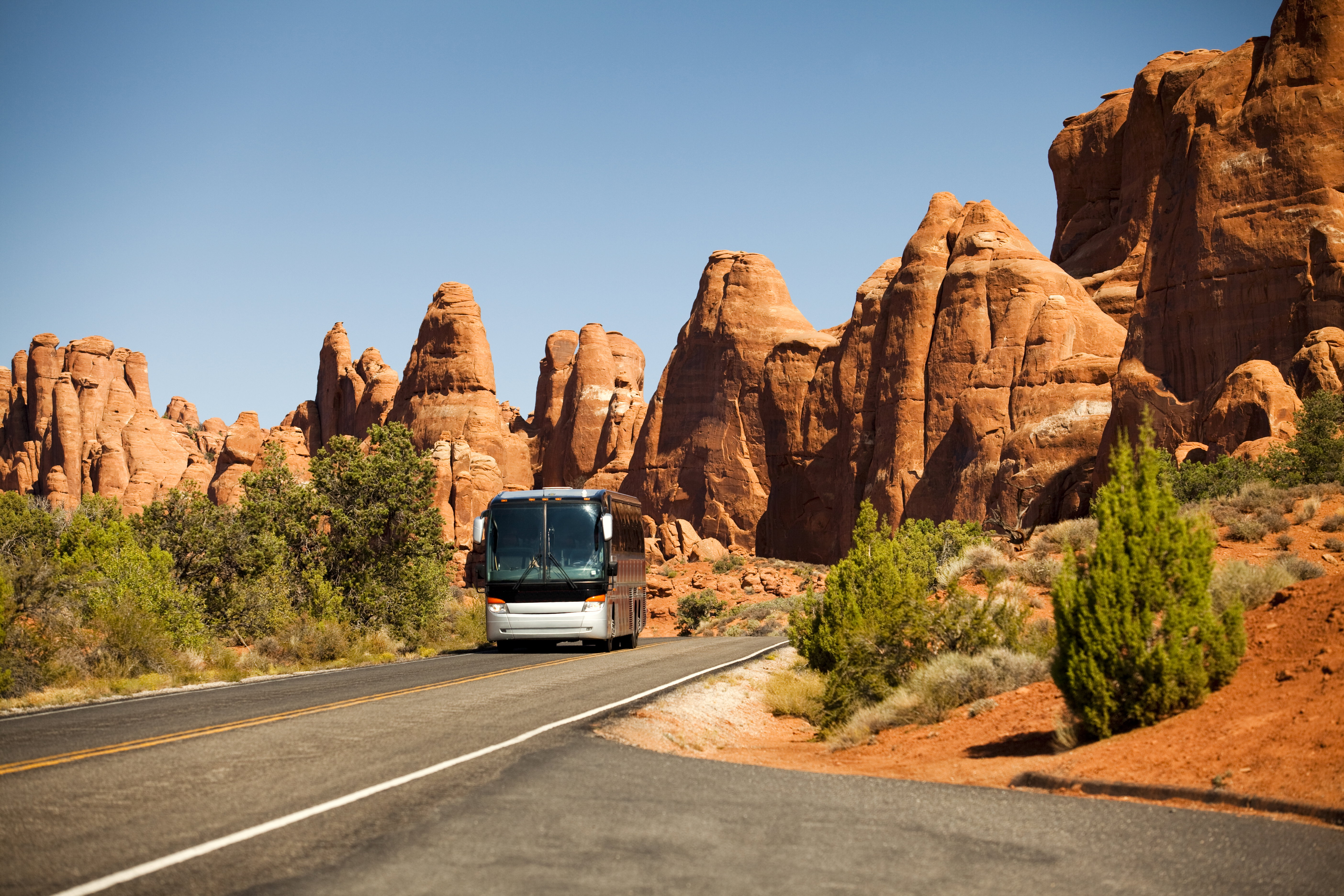 Motor coach drives tourists on vacation in the southwest USA