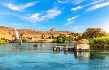 Nile riverbank near Aswan and traditional sailboat