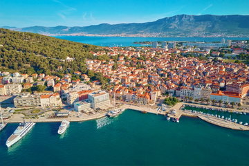 Aerial view of Split, Croatia. Cityscape of coastal touristic city with harbor with mountains in background