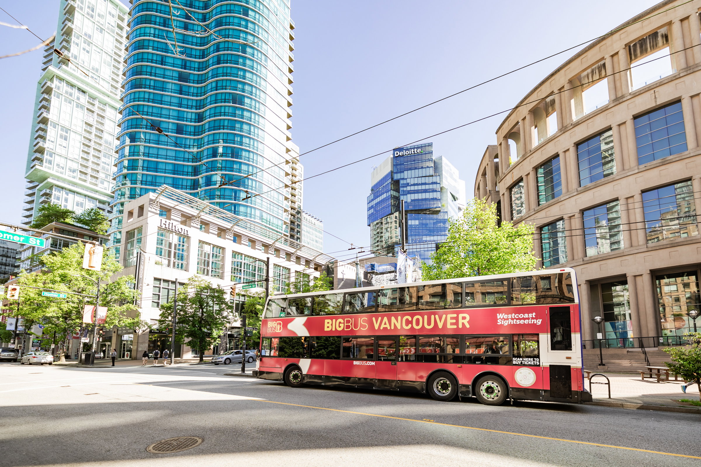 Double decker tour bus outside Vancouver Public Library, Western Canada