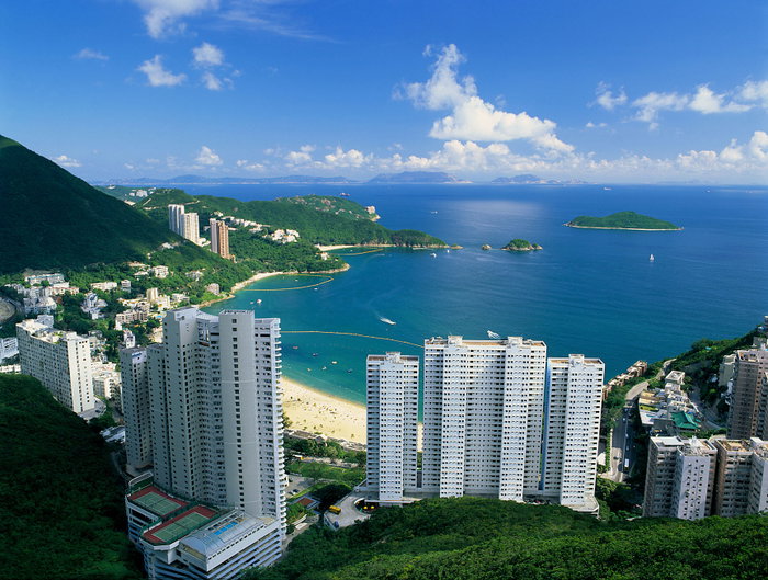 Aerial view of Repulse Bay Beach, Hong Kong with skyscrapers, beach and sea.