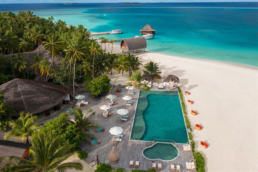 A beachfront infinity pool at the Angsana Velavaru resort in the Maldives