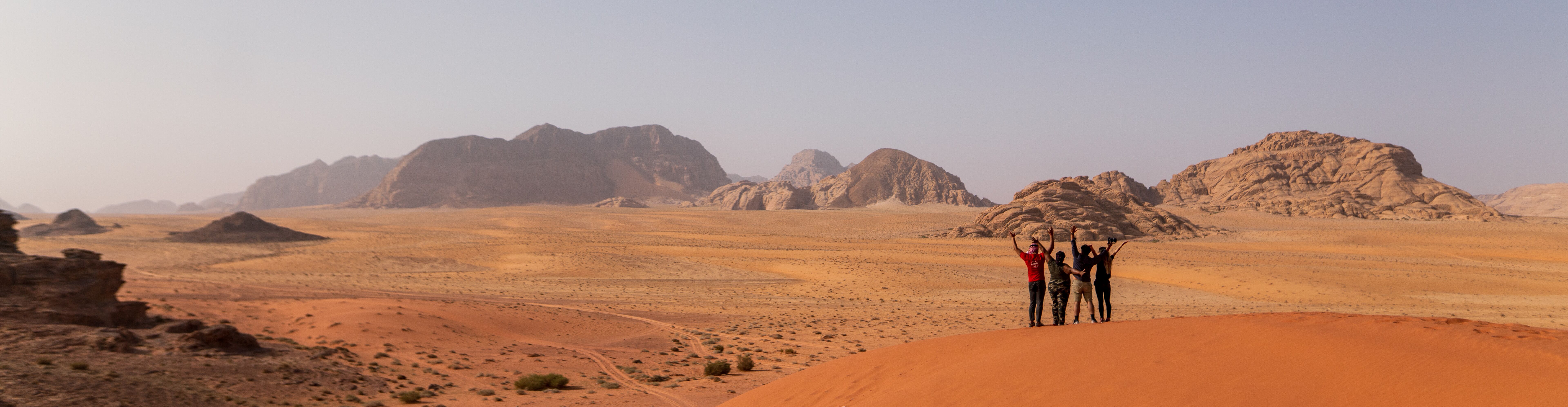 A group of young travellers sit on the top deck of a felucca sailboat on the River Nile