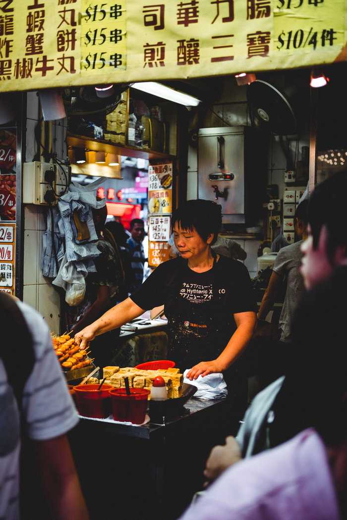 Woman cooking in street market, Kowloon, Hong Kong