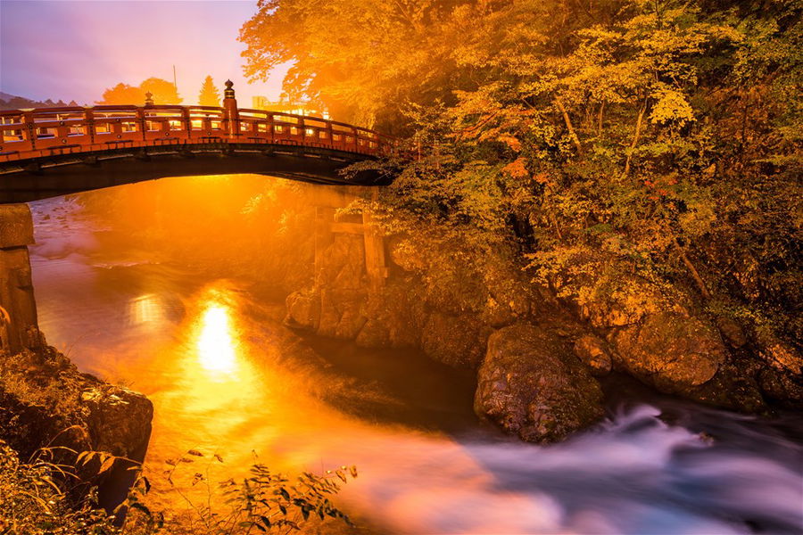 The beautiful Shinkyo Bridge at sunrise, surrounded by autumn leaves, Nikko Japan