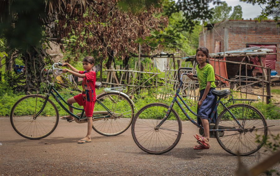 Village kids on bikes in Cambodia