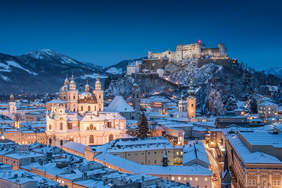 Beautiful view of the historic city of Salzburg with Festung Hohensalzburg illuminated in scenic winter twilight, Salzburger Land, Austria