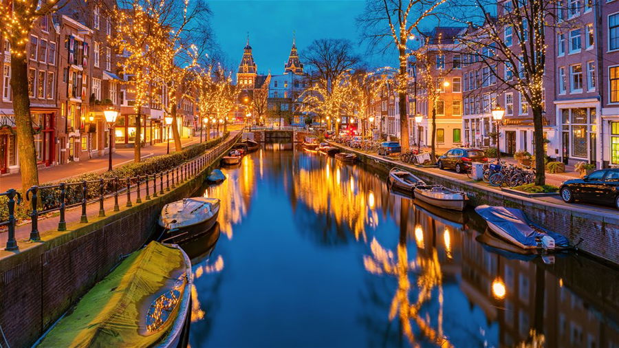 Amsterdam Netherlands canals with Christmas lights during December, canal historical center of Amsterdam at night