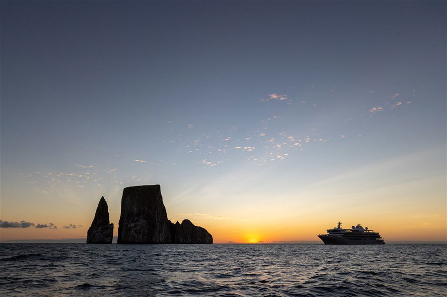 A cruise ship at sunrise in the Galapagos islands