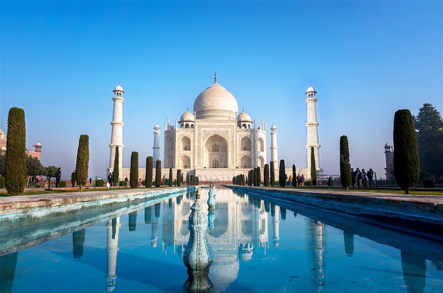 The morning view of Taj Mahal monument reflecting in water of the pool, Agra, India