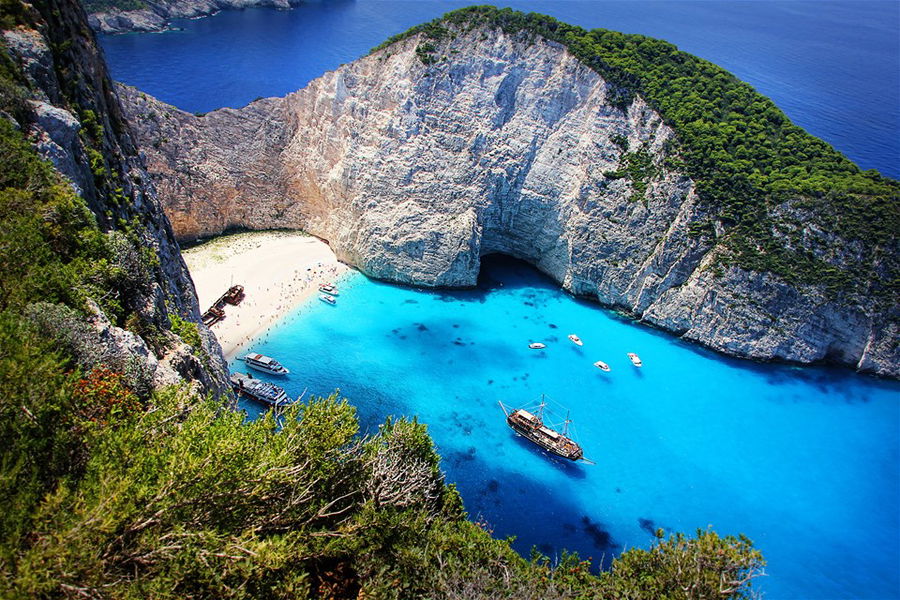 Aerial view of a beach in Zakynthos in a sheltered cove with a shipwreck