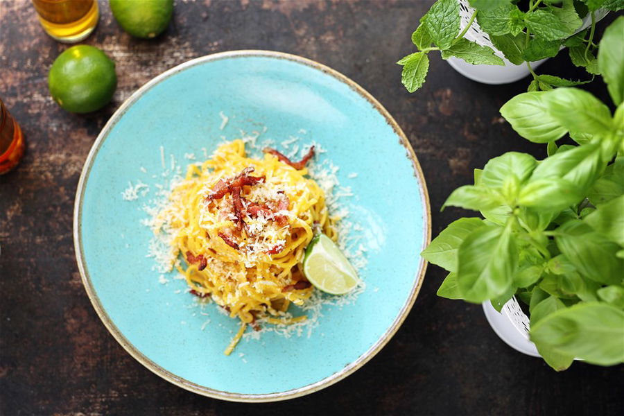 Traditional Italian cuisine, spaghetti carbonara with creamy sauce, bacon and parmesan cheese