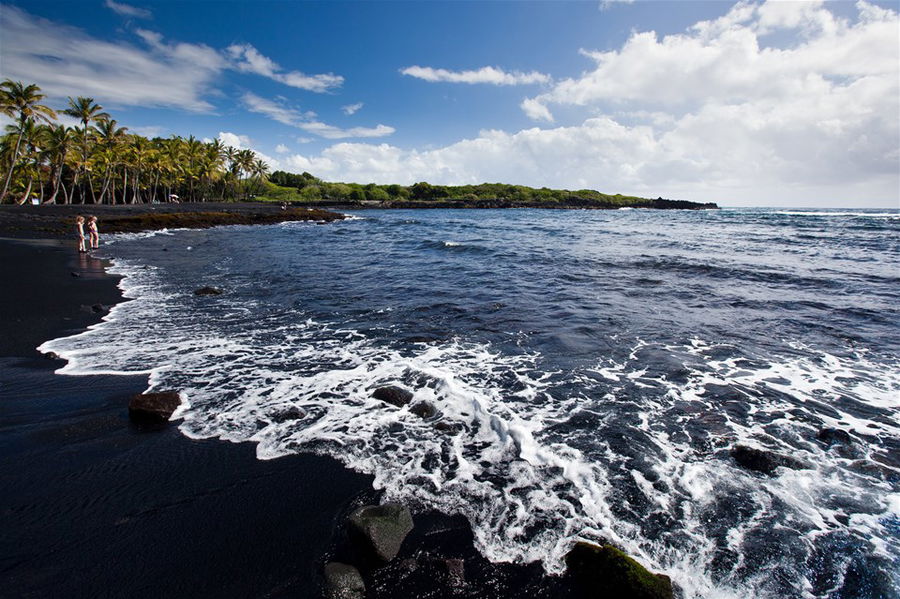 A volcanic, black-sand beach in Hawaii