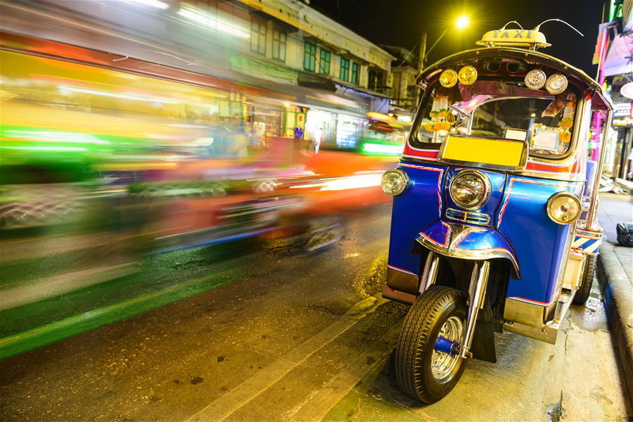 Blurred Traffic Passing a Parked Tuk Tuk Taxi, Bangkok, Thailand