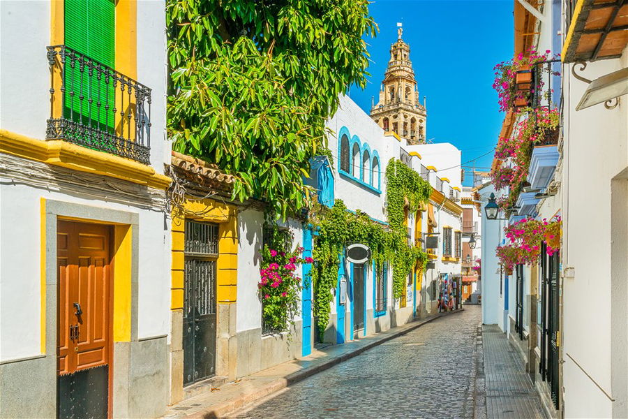 Scenic sight in the picturesque Cordoba jewish quarter with the bell tower of the Mosque Cathedral, Andalusia, Spain