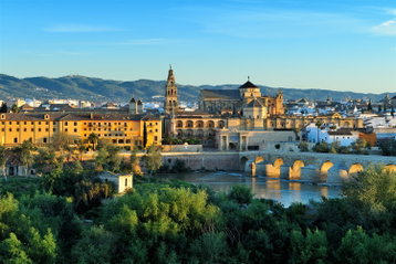 Evening view of the Mezquita and the roman bridge in Cordoba, Spain.