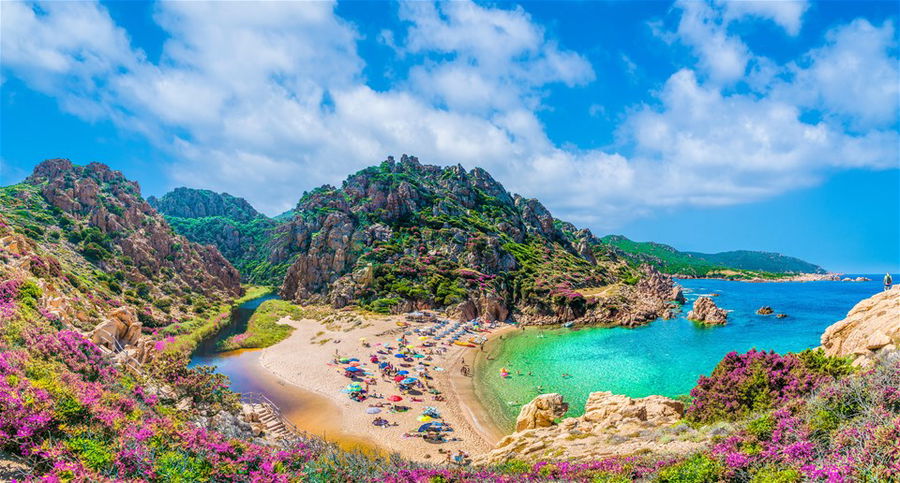 An aerial view of a beautiful white sand beach on the island of Sardinia in Italy