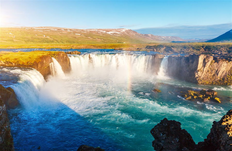 Nice views of the bright sunlit powerful Godafoss cascade, Iceland