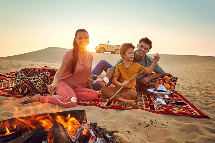 European family having a desert picnic outside Abu Dhabi