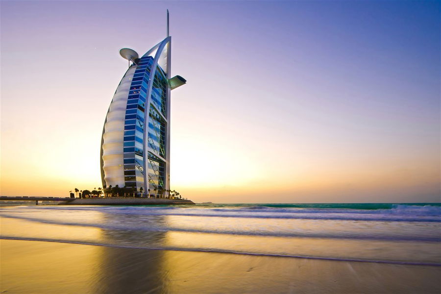 Burj Al Arab Jumeirah against a sunset sky in Dubai