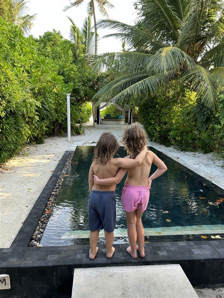 children by a pool in the maldives