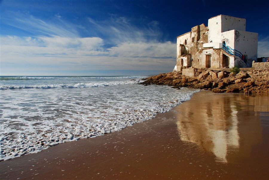 A stretch of quiet, golden beach in Essaouira, Morocco