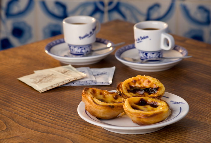 Pasteis de Nata or Pasteis de Belem; custard tarts, on a cafe table with bica coffees; Belem, Lisbon, Portugal. Image shot 2016. Exact date unknown; azulejos belem bica coffee cafe cakes coffees cookie cake cookies cream custard de delicaccy delicious espresso expresso food lisboa lisbon lisbon portugal mhq nata pasteis pastel pastelaria pastries pastry patisserie portugal portuguese portuguese cuisine table tart tarts tiles traditional